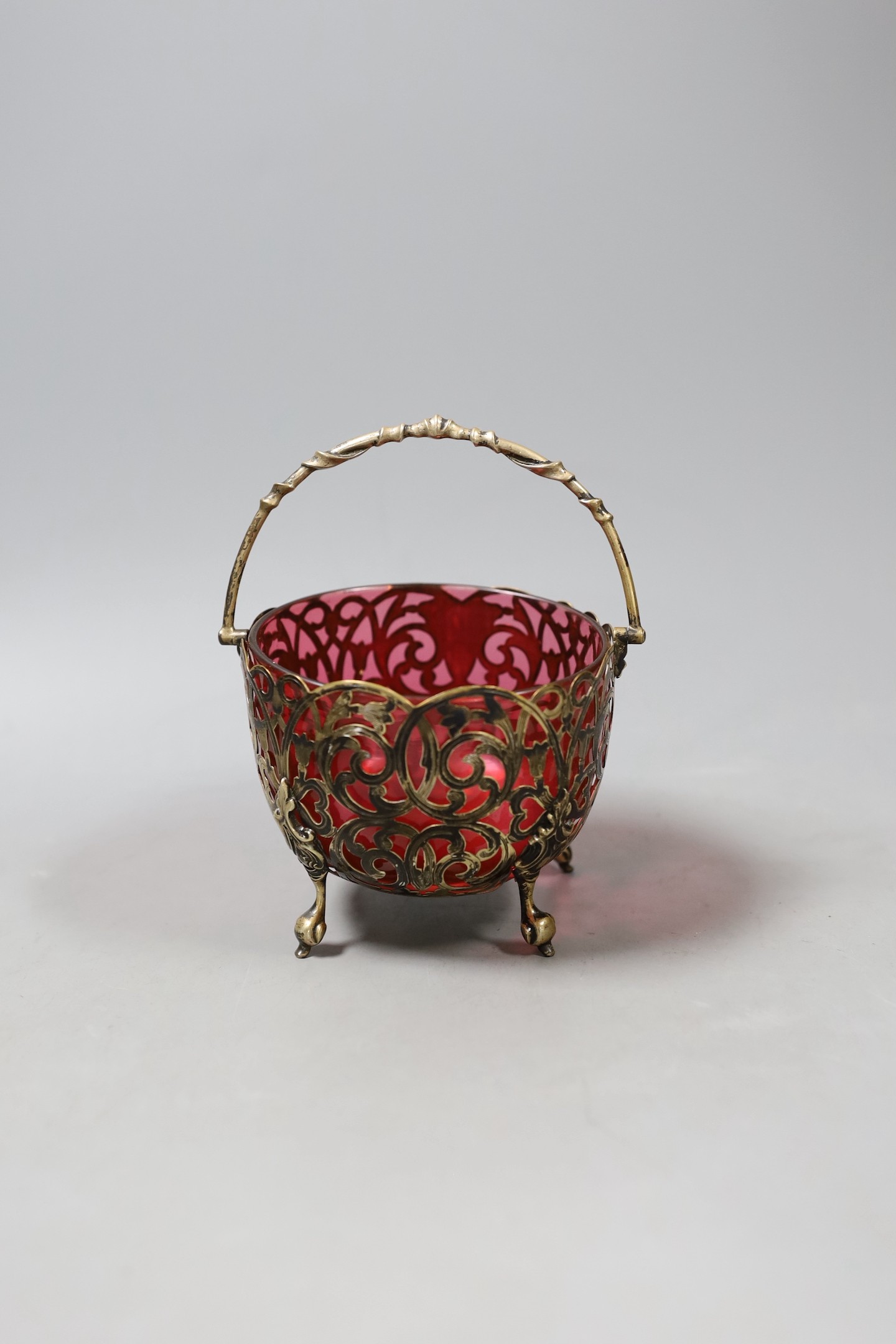 A Victorian pierced silver sugar basket, with cranberry glass liner, Birmingham, 1856, diameter 12.3cm.